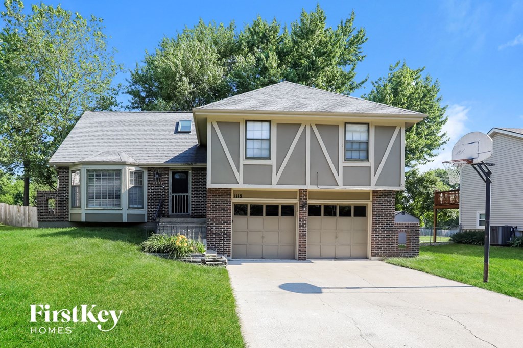 a house with a driveway and a garage door