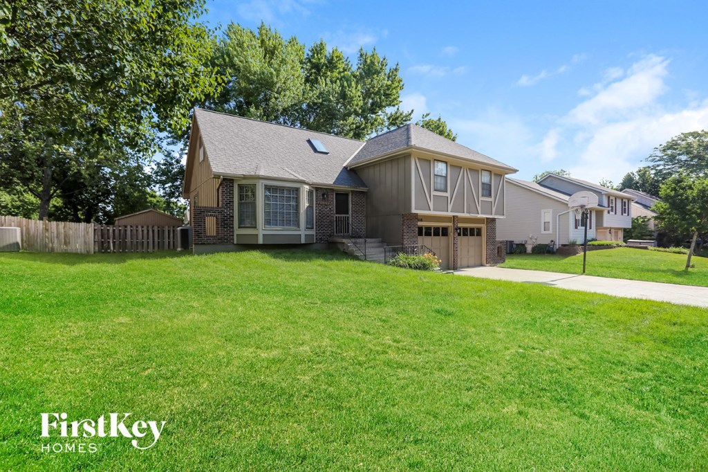 a house with a yard in front of it and a fence