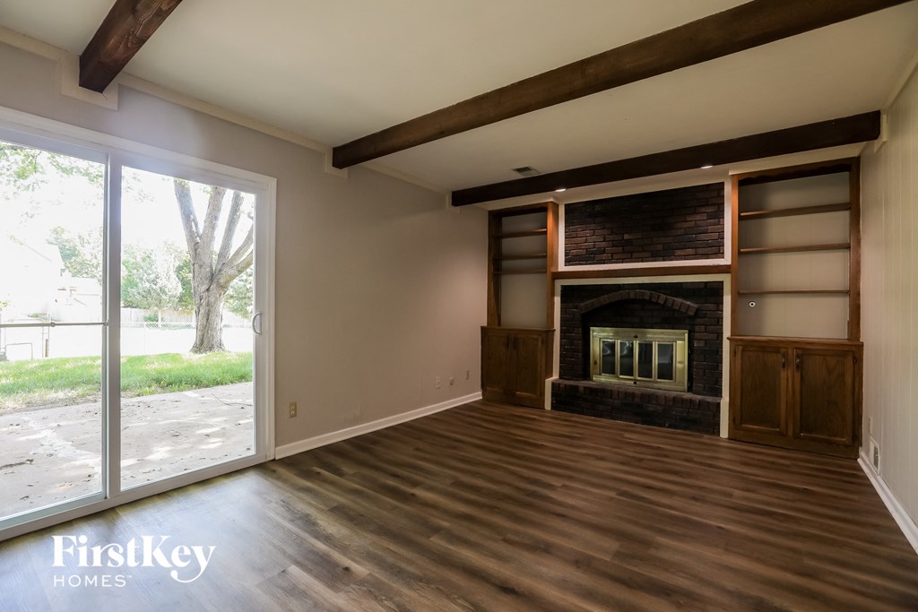 a living room with a fireplace and a sliding glass door