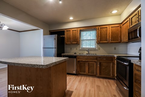 a kitchen with wooden cabinets and granite counter tops