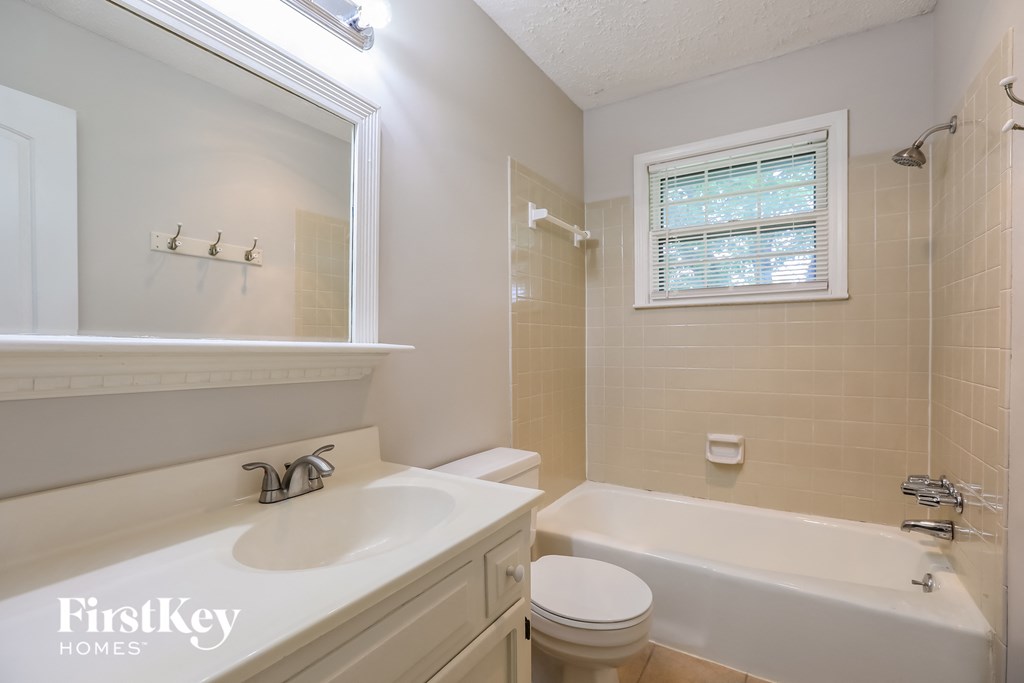a bathroom with a sink toilet and a bath tub
