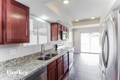 a kitchen with stainless steel appliances and granite counter tops