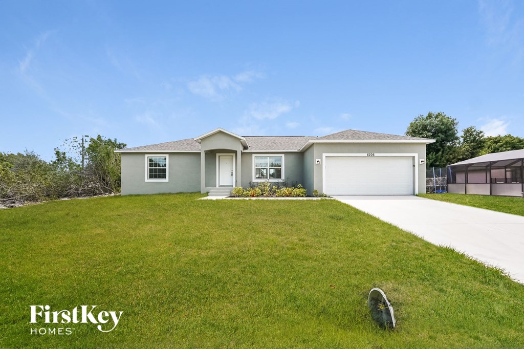 a house with a lawn and a driveway
