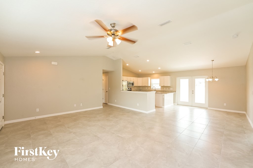 the spacious living room is open to the kitchen and dining room