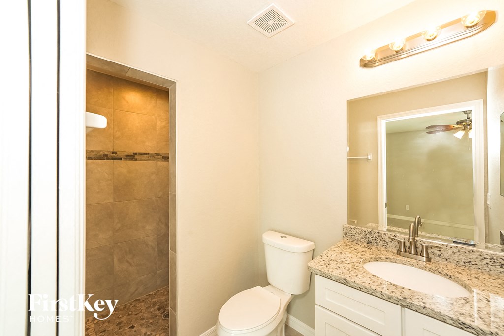 a bathroom with a sink toilet and a shower