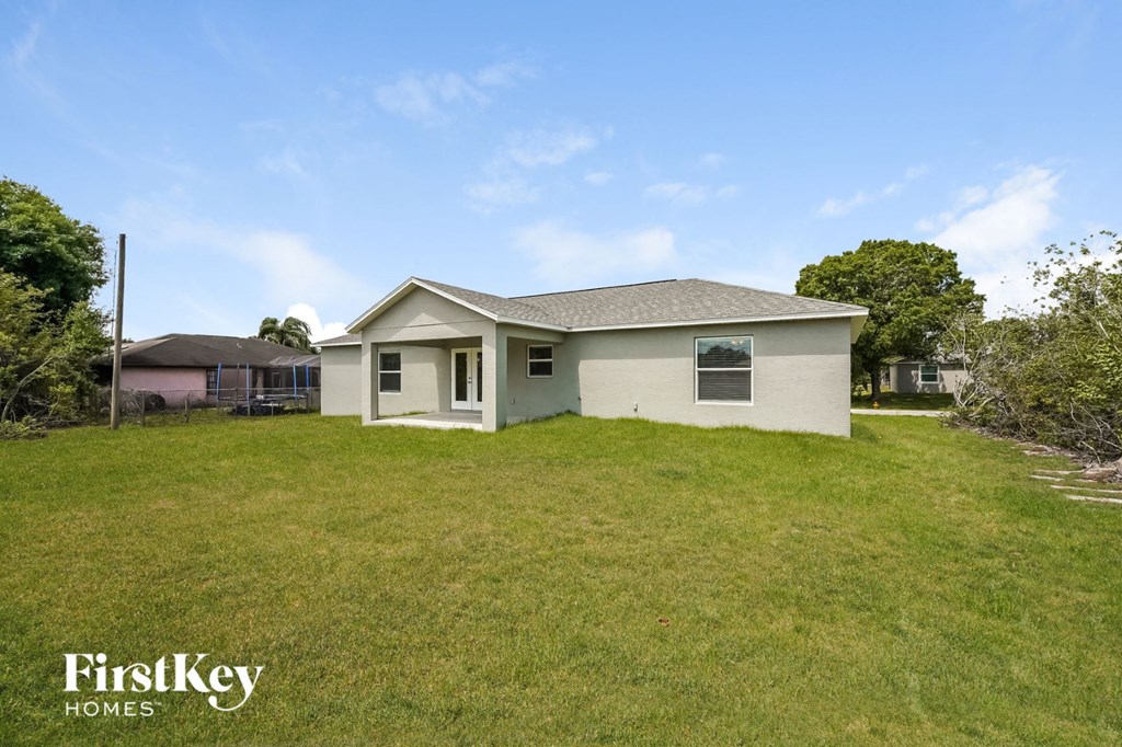 a small white house in a grassy yard