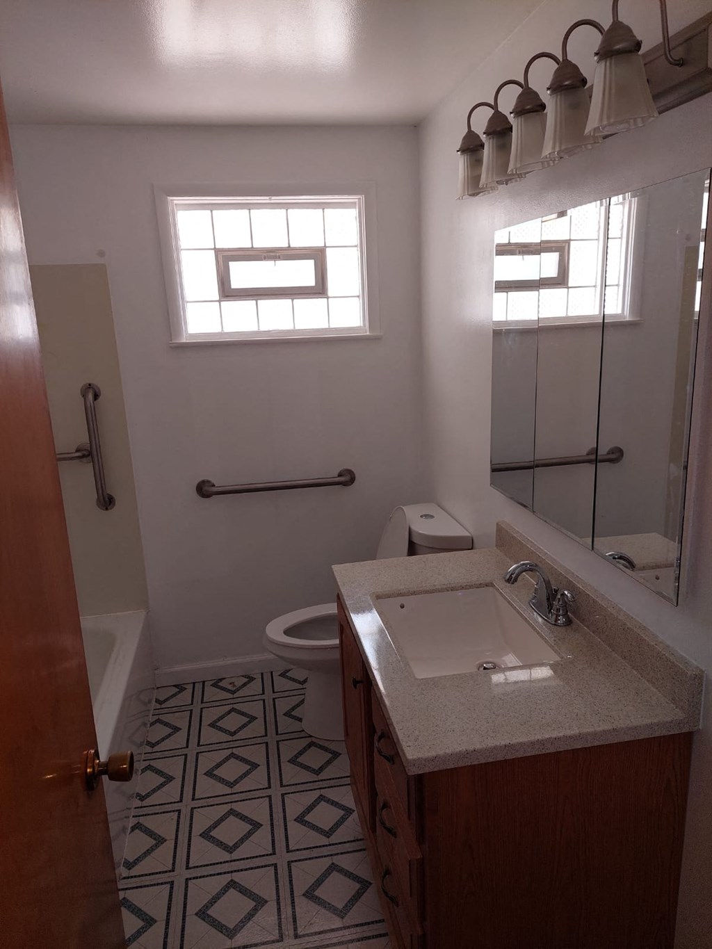 a bathroom with a sink and a toilet and a mirror