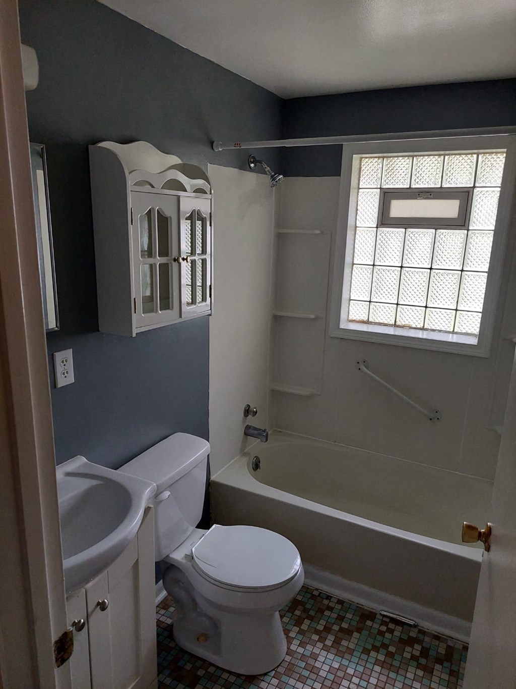 a bathroom with a toilet and a tub and a sink
