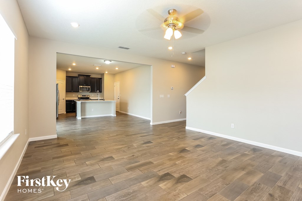 the living room is open to the kitchen and dining area