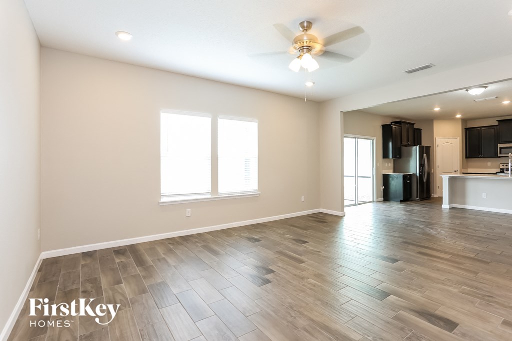 the living room is open to the kitchen and dining room