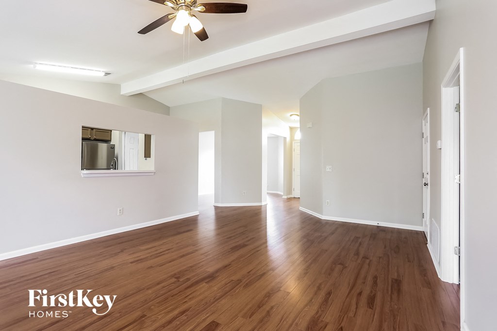 a living room with hardwood floors and a ceiling fan