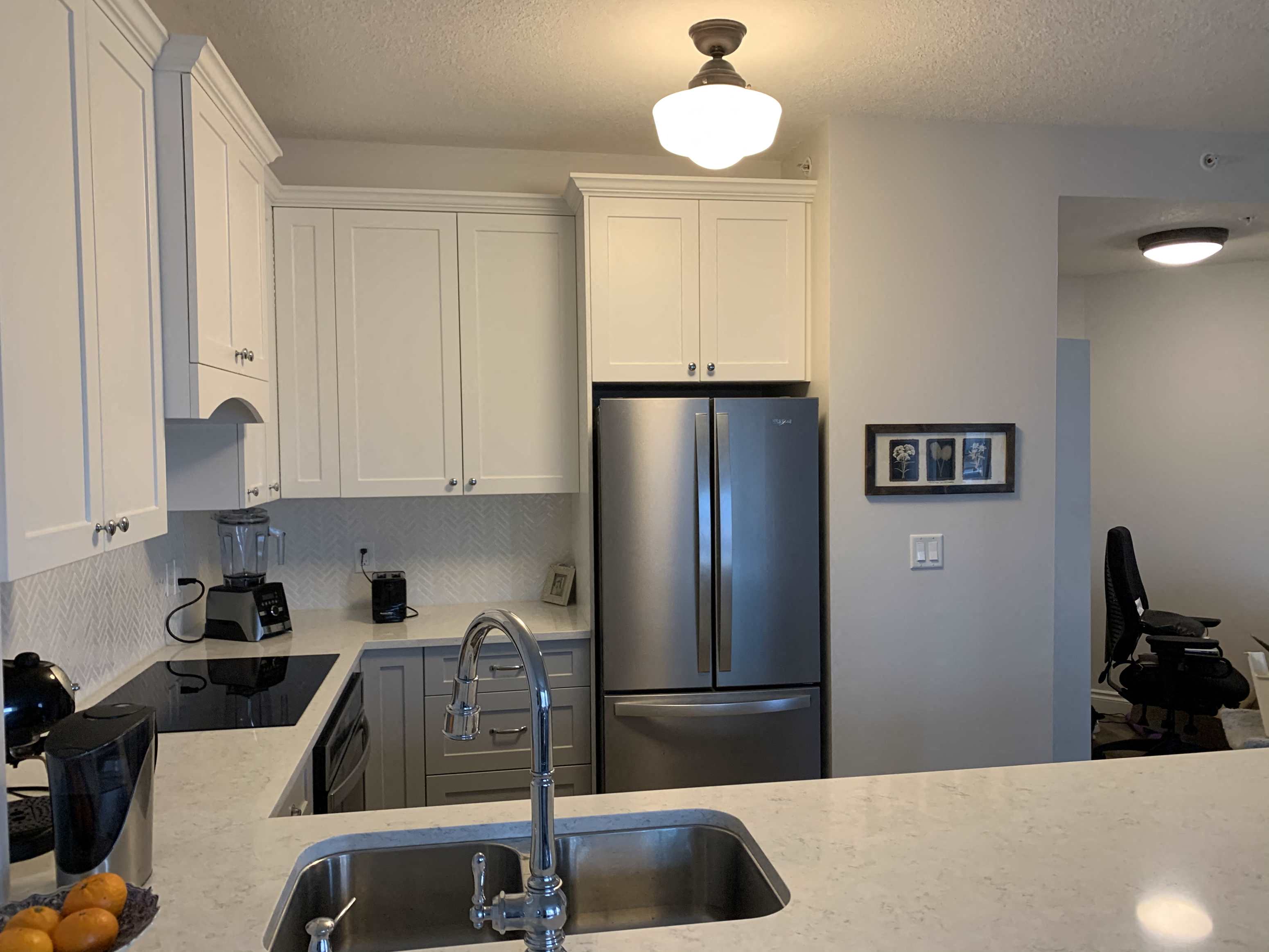 a kitchen with a sink and a refrigerator