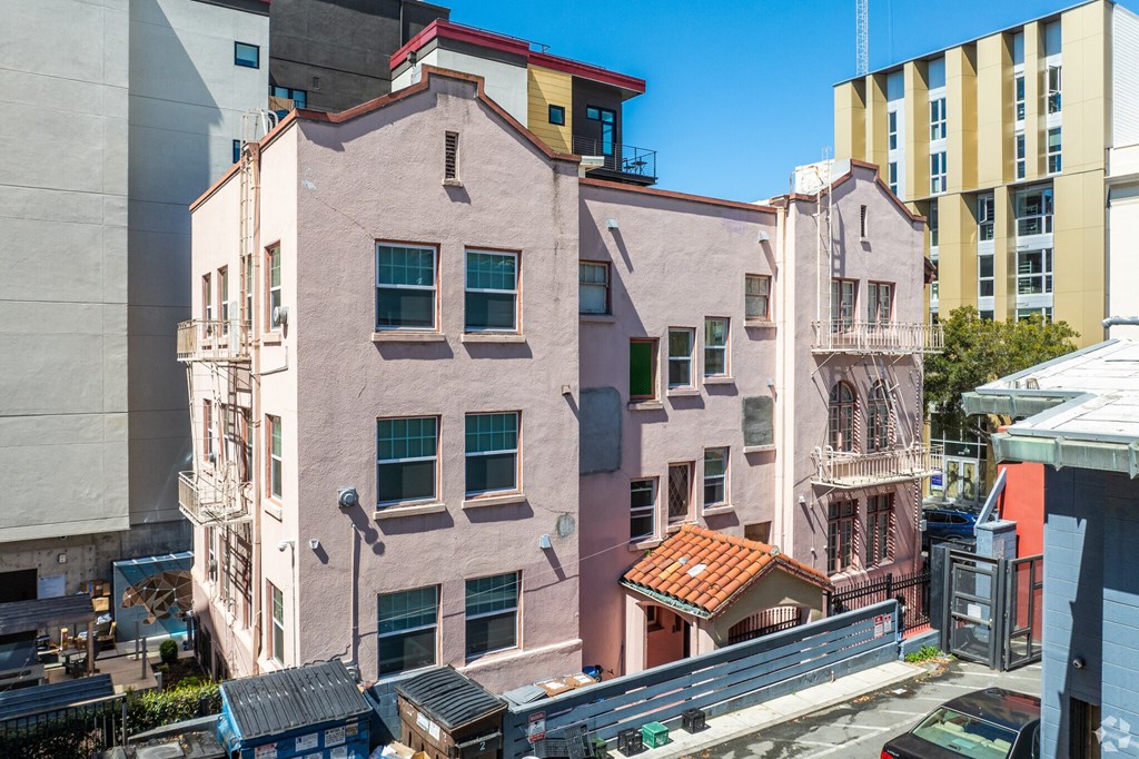 a view of an apartment building from the roof of another building