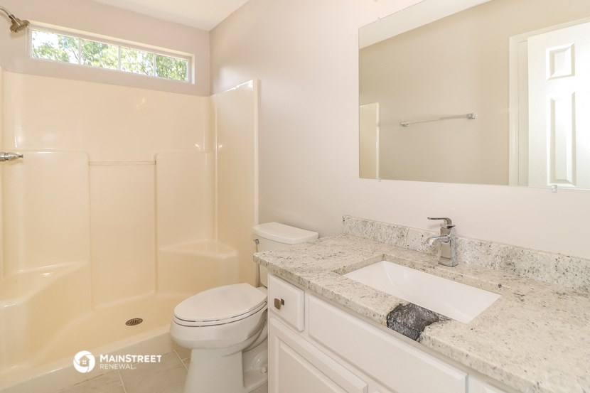 a bathroom with a sink toilet and a shower