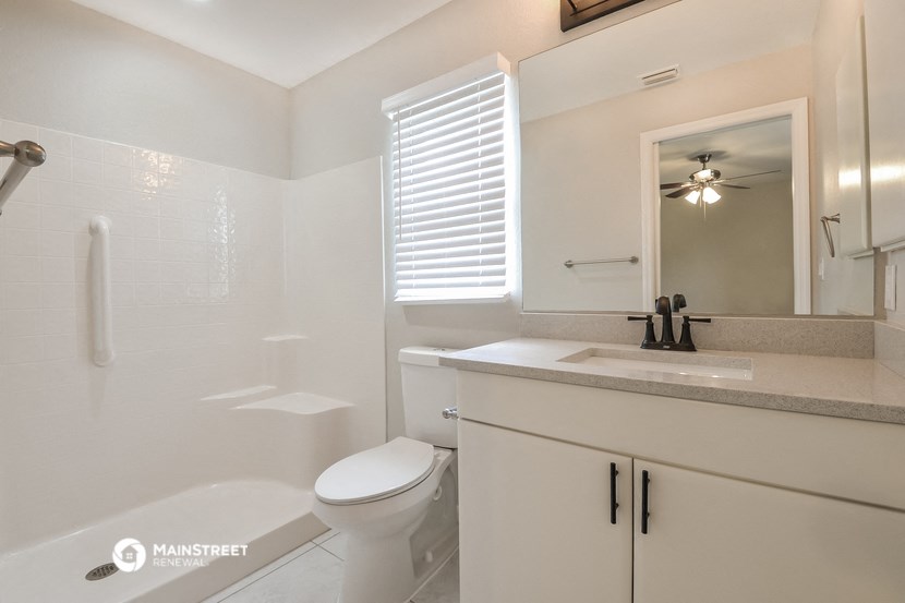 a bathroom with a sink toilet and a shower