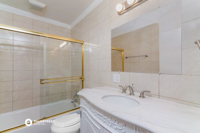 a bathroom with a sink and a shower and a toilet