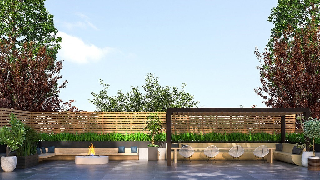 a patio with chairs and plants and a fence