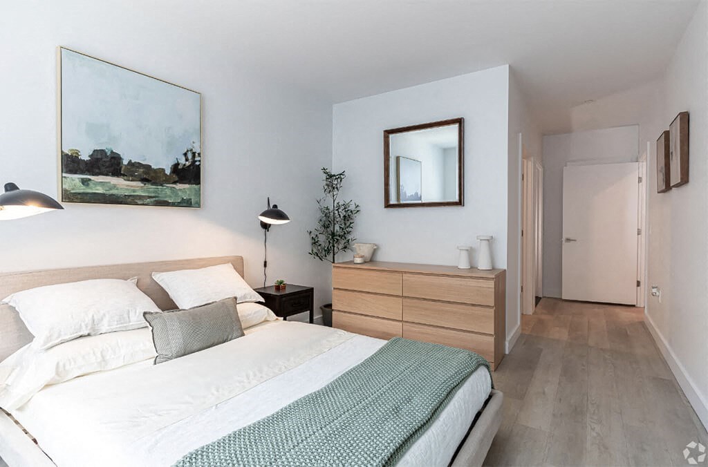 a bedroom with a bed and a mirror