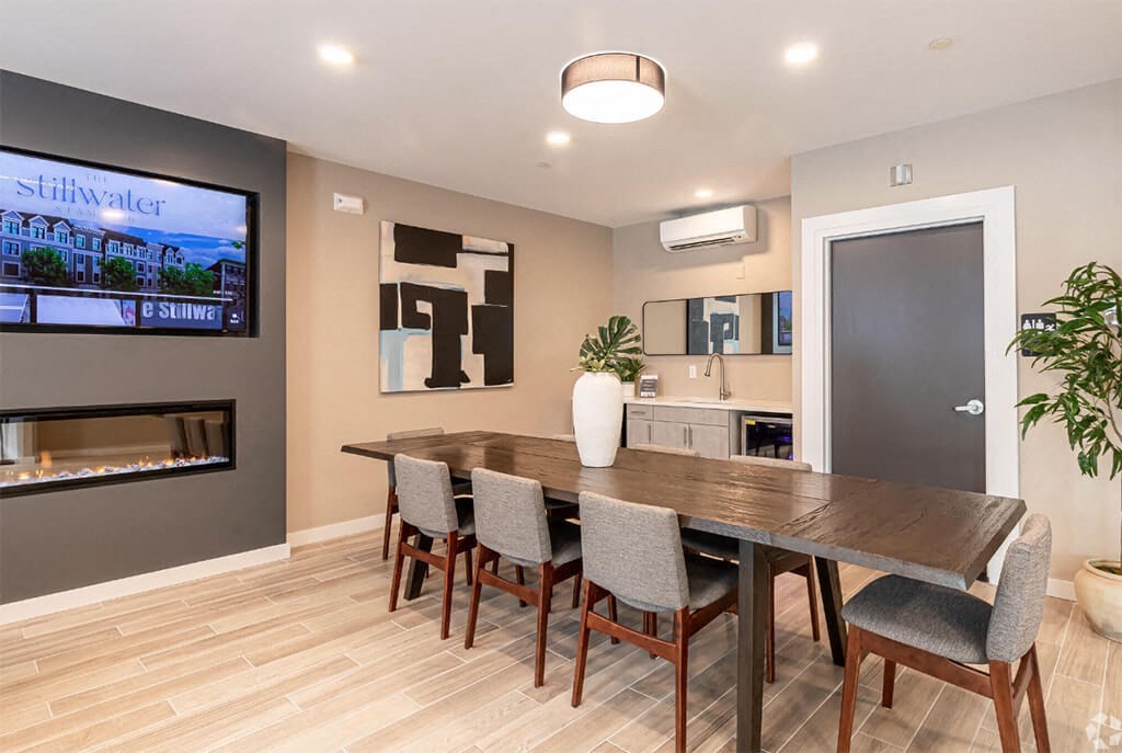 a dining room with a wooden table and chairs