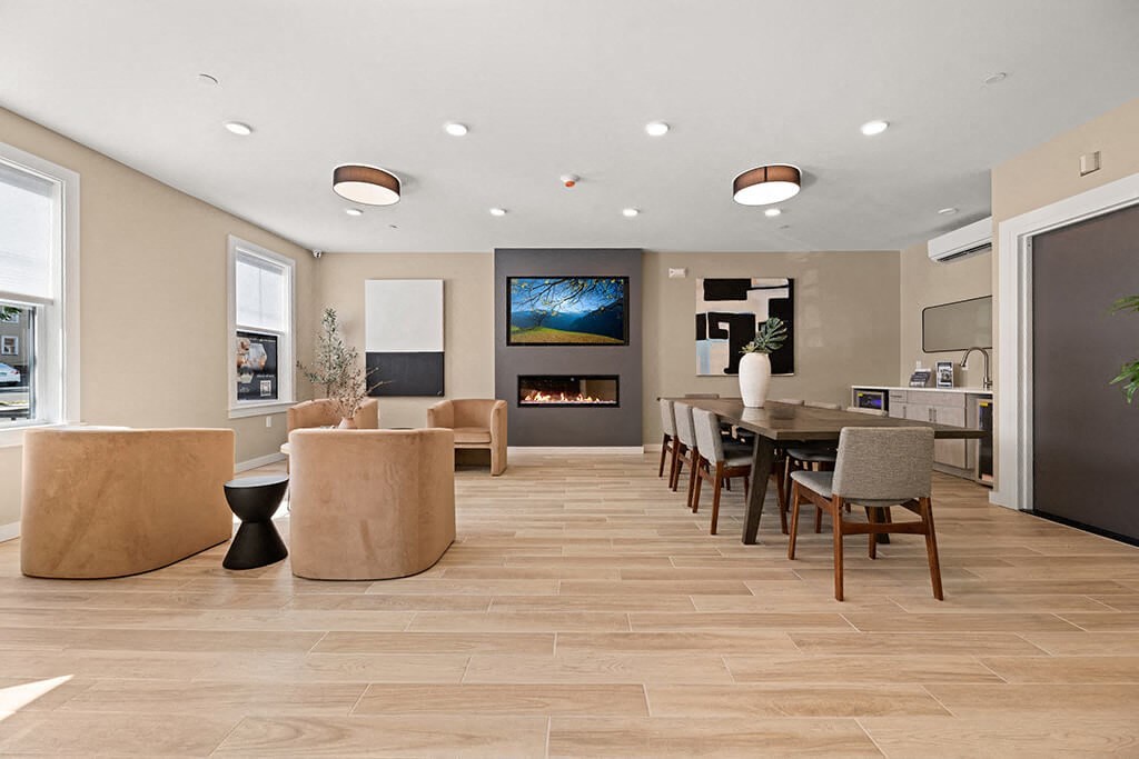 a living room with a table and chairs and a fireplace