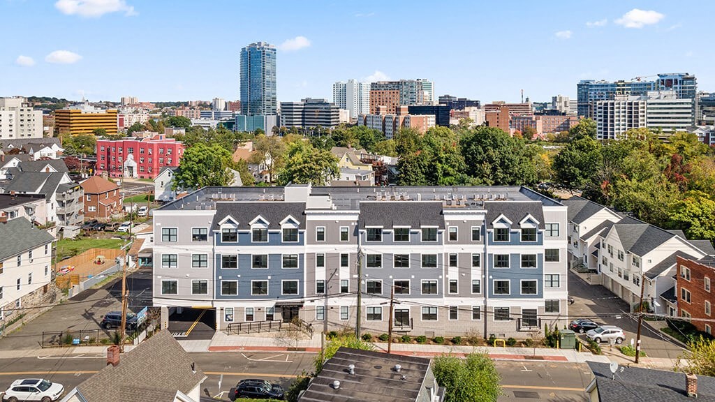 an aerial view of a building with a city in the background