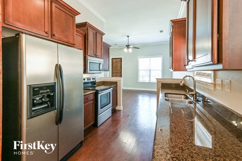 a kitchen with stainless steel appliances and wooden cabinets