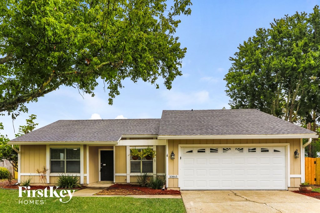 a yellow house with a white garage door