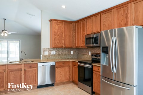 a kitchen with wooden cabinets and stainless steel appliances