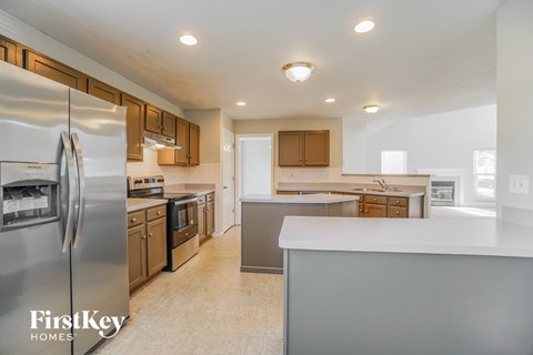 a kitchen with stainless steel appliances and a white counter top