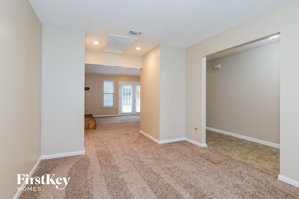 the living room and dining room are open to the hallway