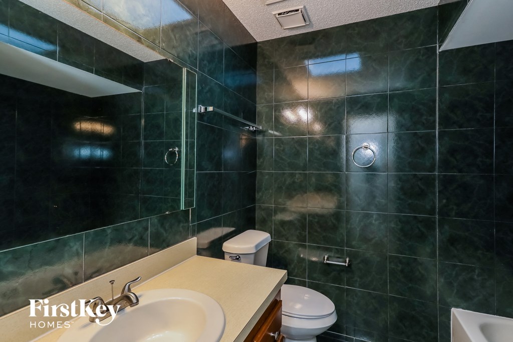 a bathroom with a sink toilet and a shower
