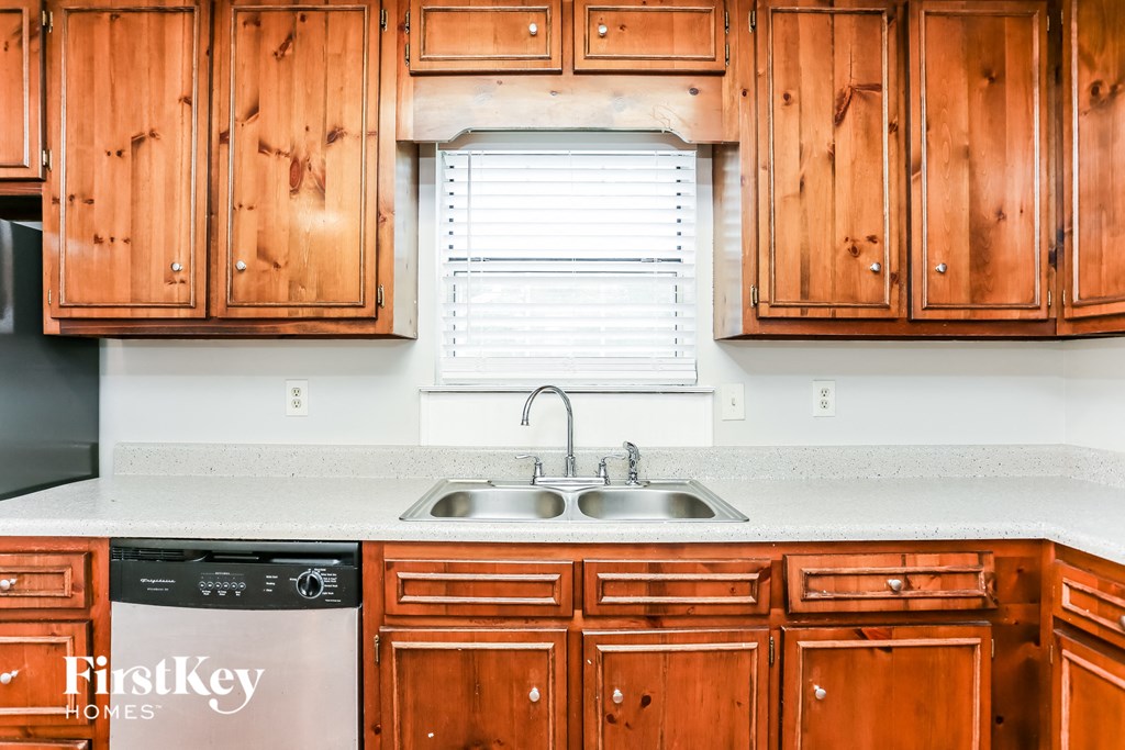 a kitchen with wooden cabinets and a sink