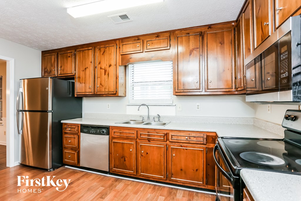 a kitchen with wooden cabinets and stainless steel appliances