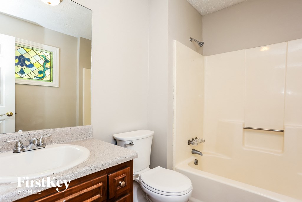 a bathroom with a sink toilet and a shower