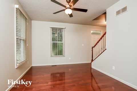 a living room with hardwood floors and a ceiling fan