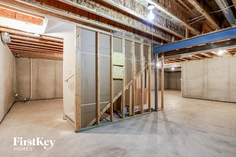 a large unfinished basement with a staircase in it