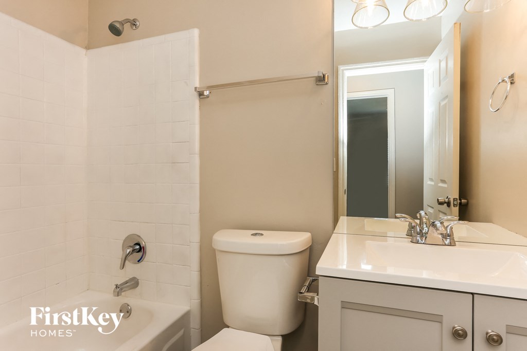 a bathroom with a toilet and a sink and a mirror