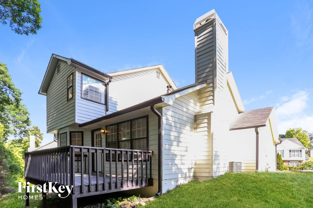 a small house with a deck on a hill