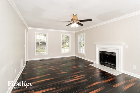 a living room with hard wood floors and a fireplace