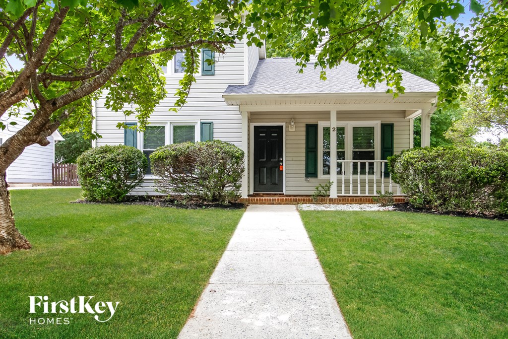 A house with a white porch and a black door.