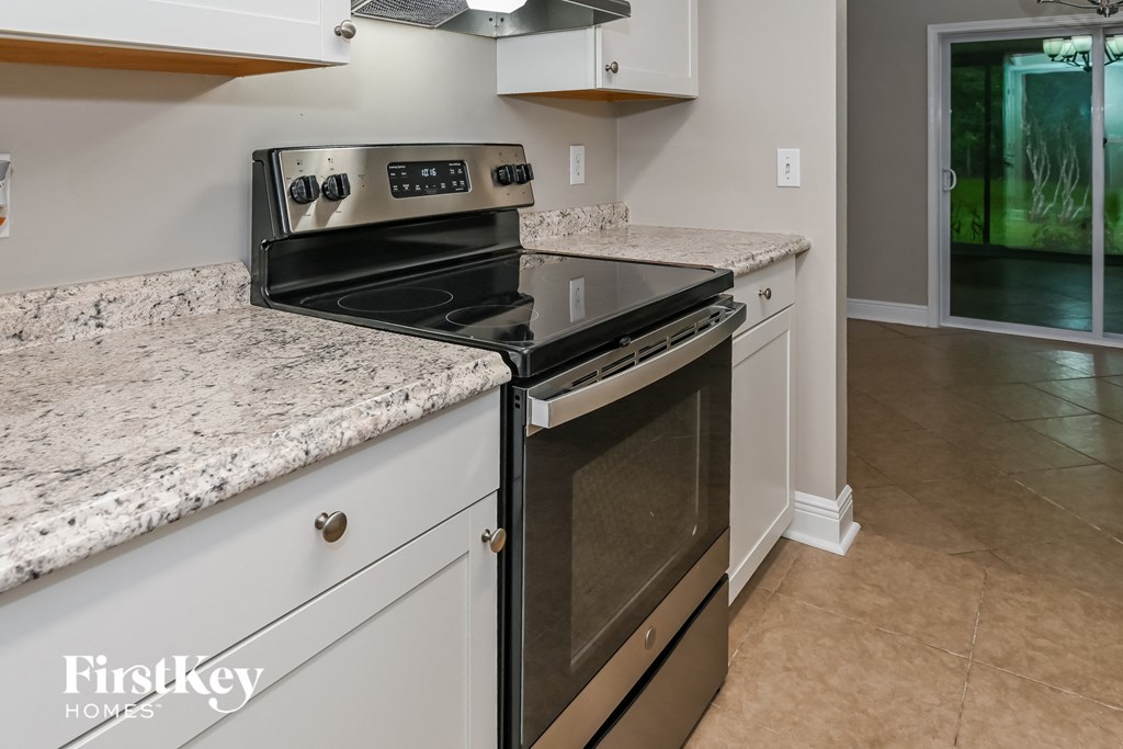 a kitchen with granite counter tops and a stove and oven