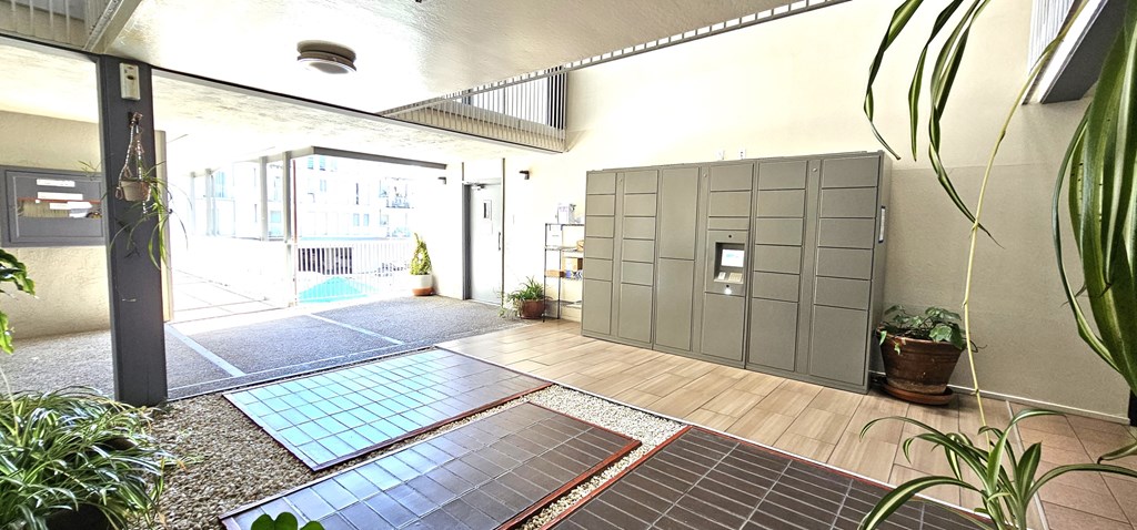 the entrance of an apartment building with a lobby and a large door