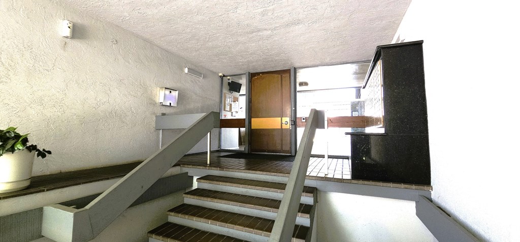 the entryway of a building with stairs and a door