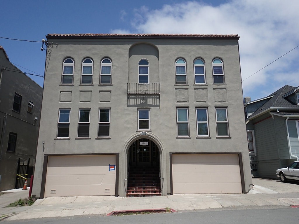 a building with two garage doors on a city street