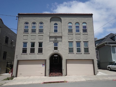 a building with two garage doors on a city street