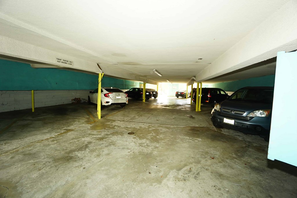 the inside of a parking garage with cars parked in it