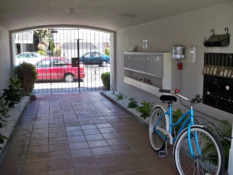 a bicycle parked in front of a building with a patio