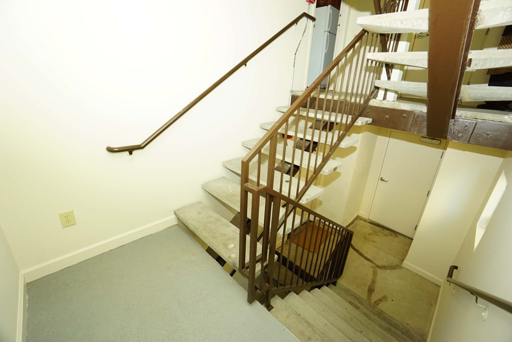 a stairwell in a home with wooden stairs