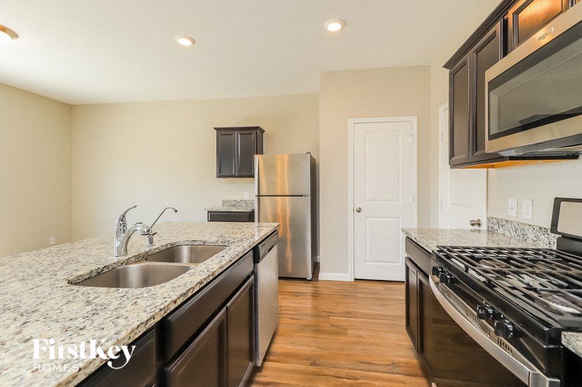 a kitchen with granite counter tops and stainless steel appliances