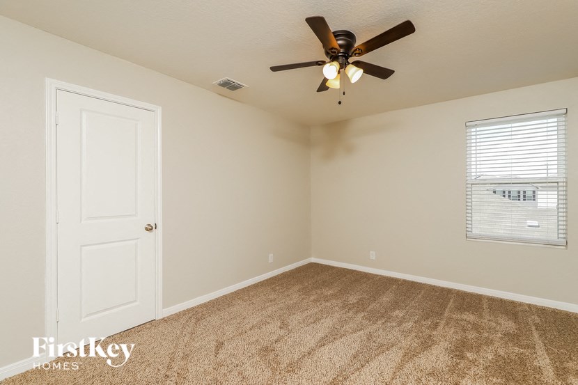 the living room of a home with a ceiling fan